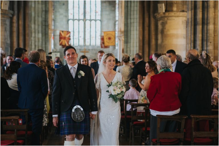 bride and groom on their wedding day at church of the holy rude and cowanes hospital