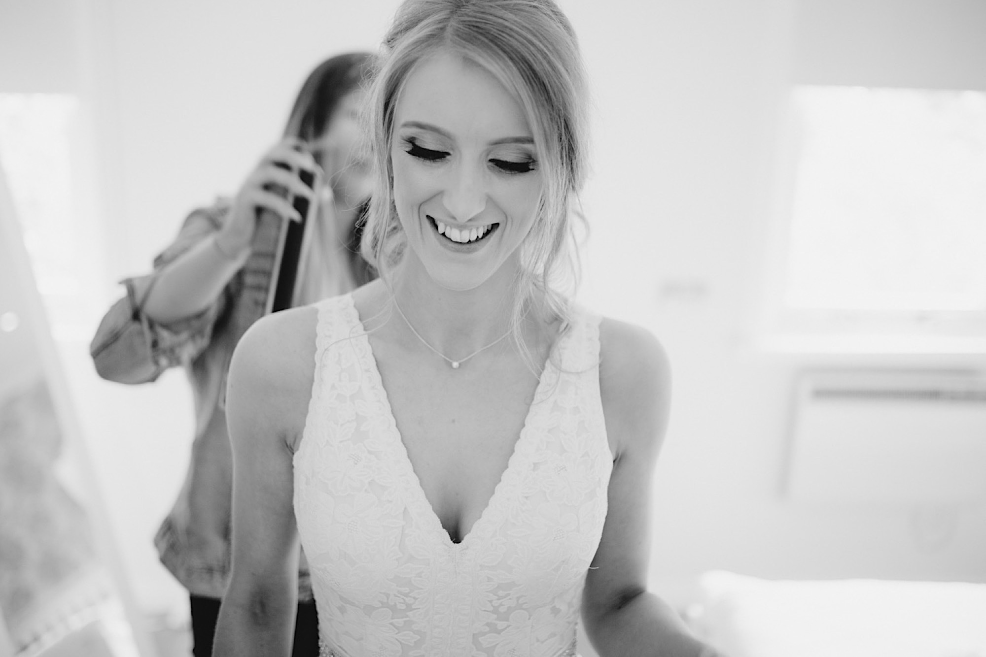 bride having her dress buttoned up cruin loch lomand