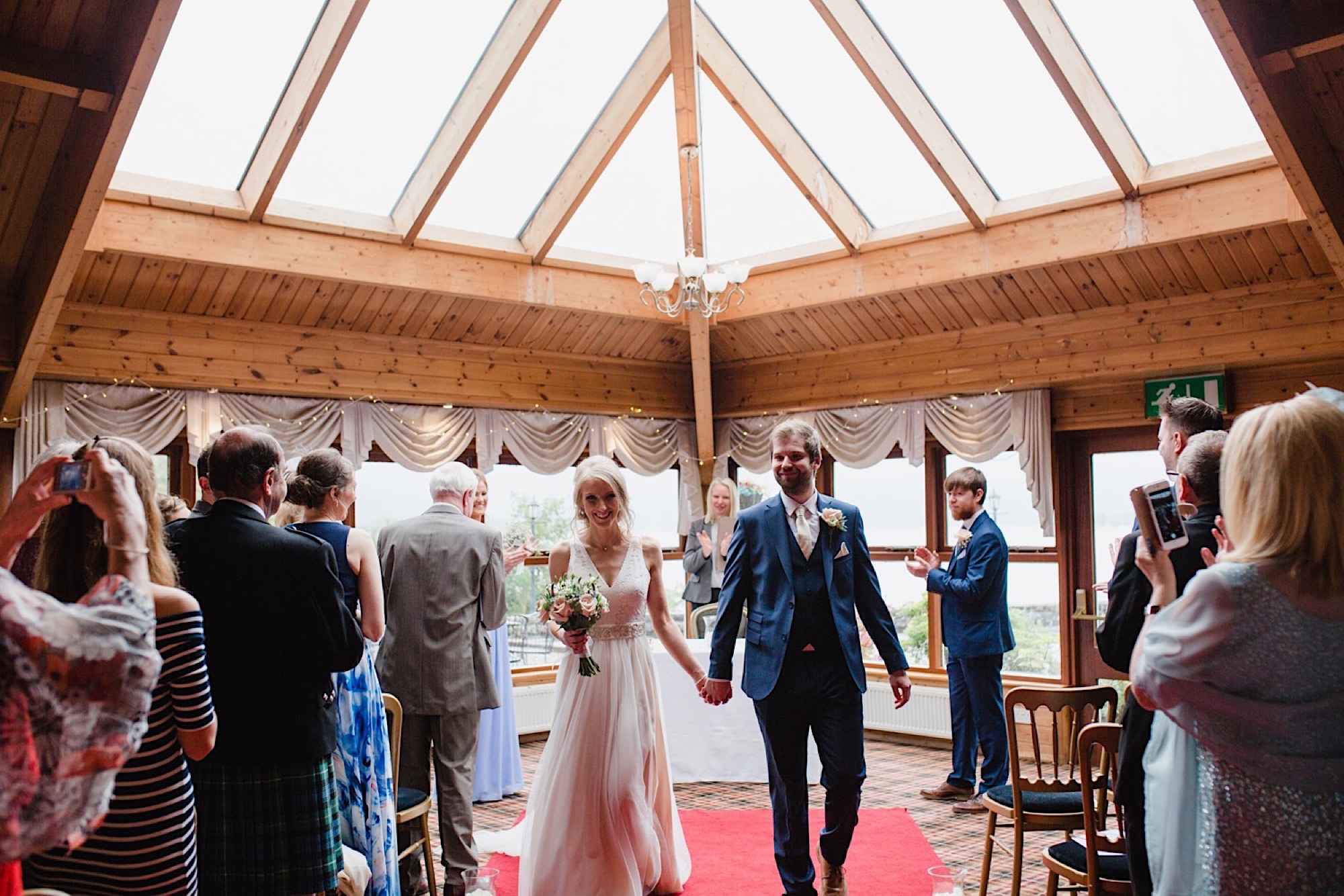 the cruin loch lomand wedding ceremony walking up isle as married couple