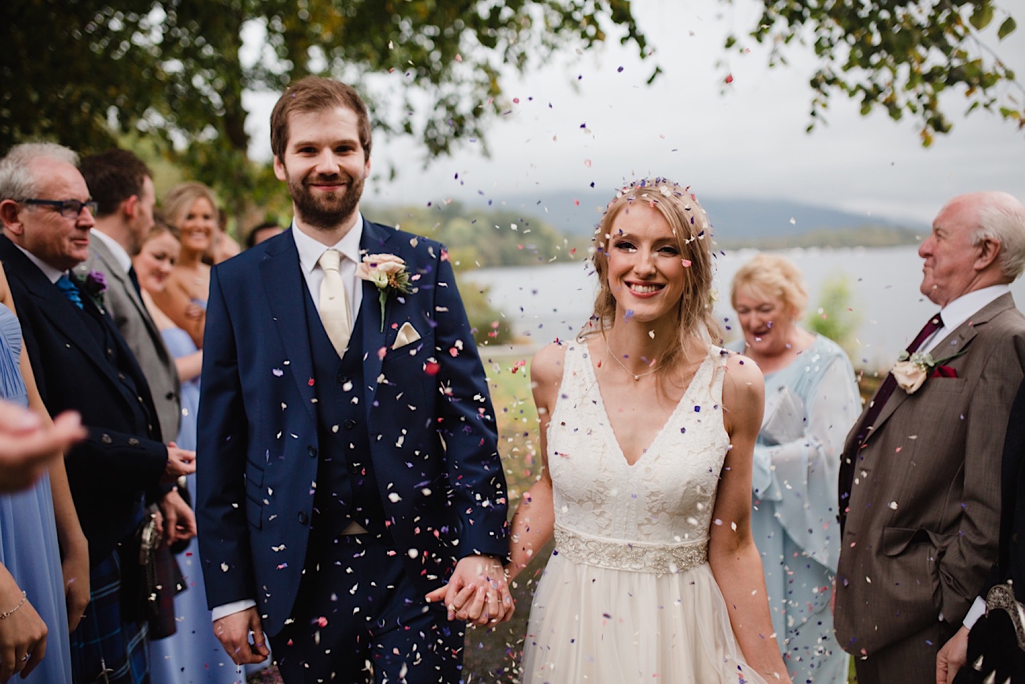 bride and groom having confetti chucked on them loch lomand