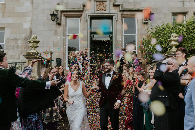 couple have confetti thrown over them at netherbyres house wedding